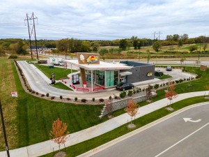 Aerial view of a fast food restaurant with a modern design and surrounding landscaping.