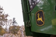 Close-up of green agricultural equipment with a blurred background.