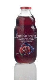Bottle of PureGranate 100% pure pomegranate and Isabella grape juice with a dark red liquid inside.