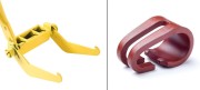 A yellow equipment attachment with two prongs and a red metal hook shaped like a loop.
