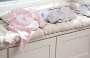 Baby clothing on window seat